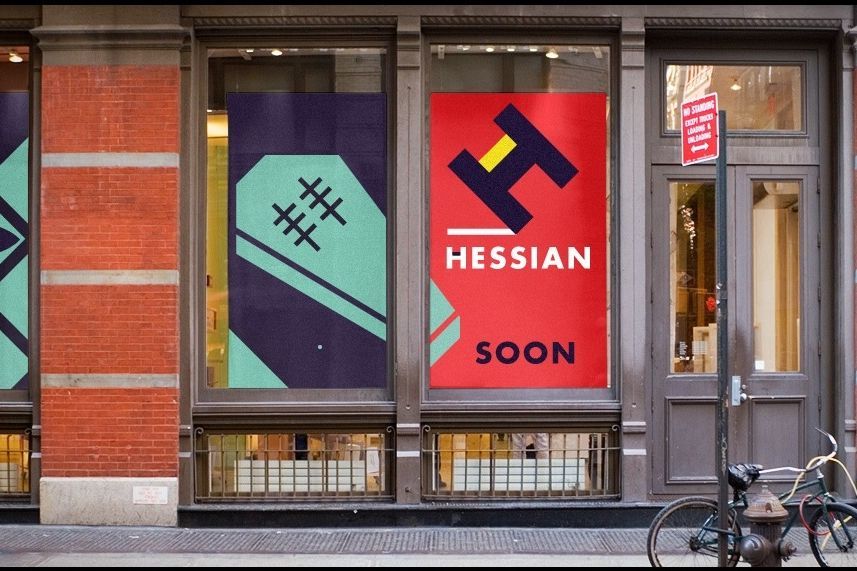 A SoHo storefront window carrying posters for Hessian, a brand with no product